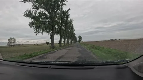 Windshield wipers clean a car window in slow motion as washer fluid sprays .. Stock Footage 345605063