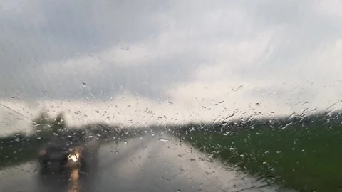 Windshield wipers clean the windshield of a moving car. Video stock 156950034