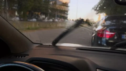 Windshield wipers cleaning car glass close-up interior view with washer fluid Stock Footage 333649305