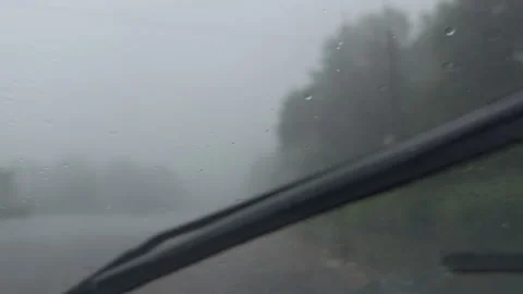 Windshield wipers cleaning rain from car window Stock Footage 338409085