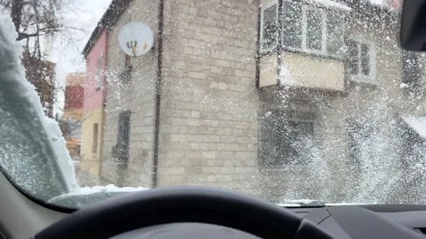 Windshield wipers cleaning snow from car windshield Stock Footage 301349087