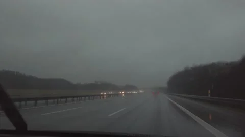 Windshield wipers clearing the car window on a wet highway Stock Footage 170939227