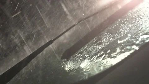 Windshield wipers, rain drops falling on the car window. Heavy rain in the night Stock Footage 80307511