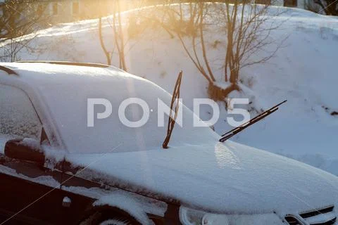 Windshield Wipers On Snow-Covered Car