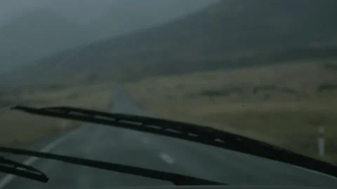 Windshield wipers sweep the rain-filled windshield, in New Zealand Stock Footage 217397661