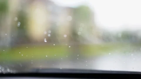 Windshield wipers wash away raindrops on windshield of a car. Selective focus Stock Footage 210155900