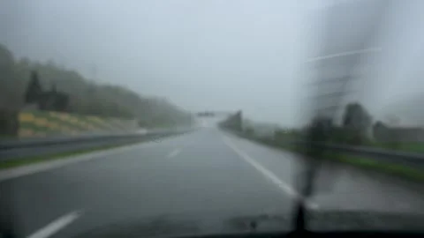 Windshield wipers working fast in heavy rain on a moving vehicle. Video stock 335026229