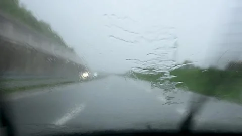 Windshield wipers working fast in heavy rain on moving vehicle. Car wipers Video stock 335026231