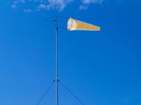 Windsock against a blue sky with clouds Stock Photos