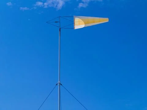 Windsock against a blue sky with clouds Stock Photos