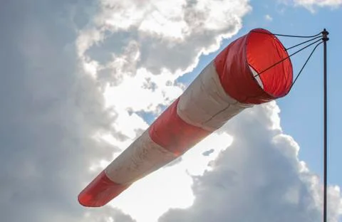 Windsock against the sky with clouds. Closeup. Stock Photos