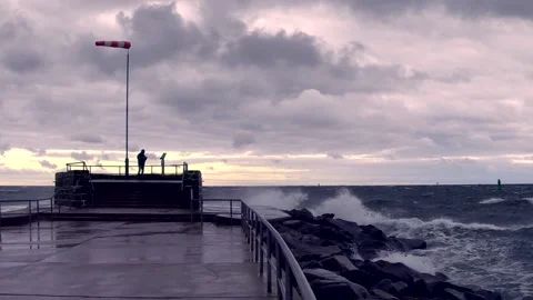 Windsock on baltic sea - storm, ocean, sprays, waves, clouds, wind - real time Stock Footage 141149376