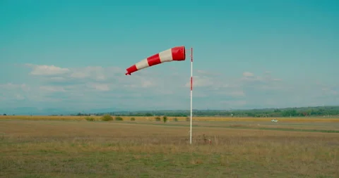 WIndsock blow in wind on hot summer day in airport Stock Footage 132484569