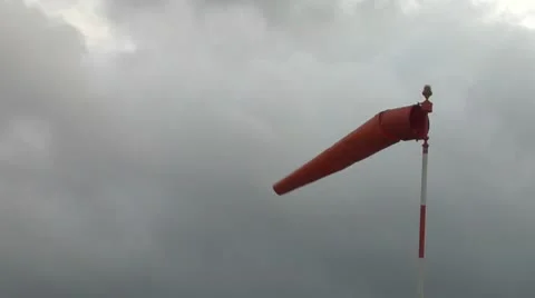 Windsock blowing about on grey windy day Stock Footage 8984121