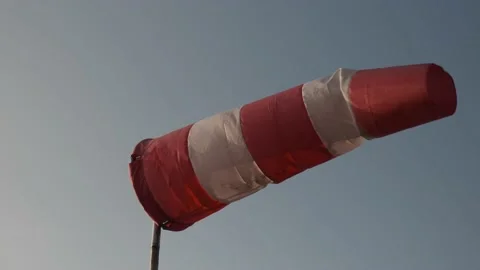 Windsock blowing with blue sky in the background. Slow motion. Stock Footage 229008672