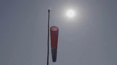 A Windsock Blowing In The Wind With Natural Sun In A Blue Sky Stock Footage 169498041