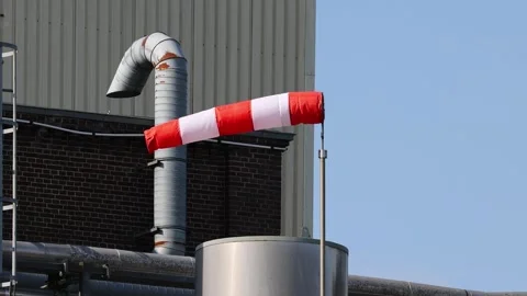 Windsock blowing on a windy day at industrial plant Stock Footage 342389794