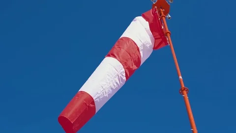 Windsock develops on blue cloudless sky background. 動画素材 106090728