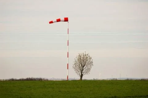 Windsock on Field with Isolated Tree Background Stock Photos