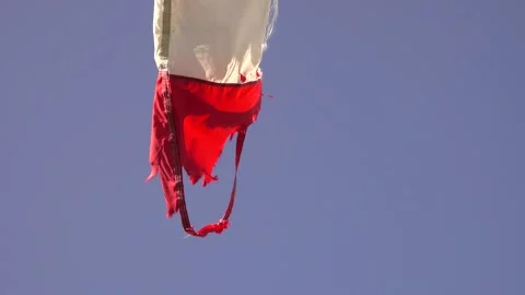 Windsock fluttering in the wind, red white frayed end Stock Footage 158611166