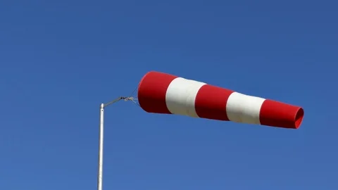 Windsock Flutters in Strong Wind Showing Wind Direction and Speed Against Stock Footage 126256496
