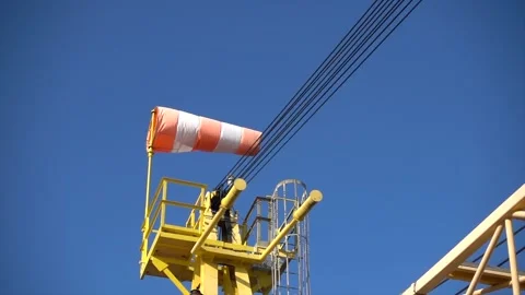 Windsock flutters in a strong wind showing wind direction and speed against perf Stock Footage 220201822