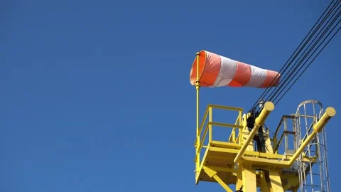 Windsock flutters in a strong wind showing wind direction and speed against perf Stock Footage 224091969
