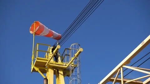Windsock flutters in a strong wind showing wind direction and speed against perf Stock Footage 231020684