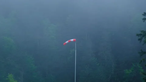Windsock in the fog of clouds in the mountain forest aerodrom Stock Footage 278097809