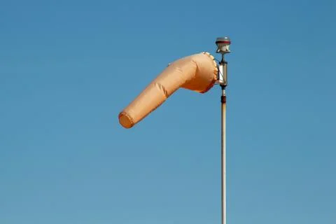 Windsock indicating wind direction and relative speed on blue sky background Stock Photos