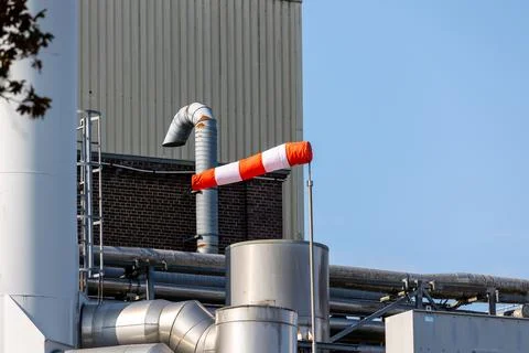 Windsock indicating wind direction at industrial factory facility Stock Photos