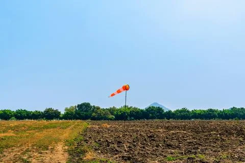 Windsock indicator of wind in meadow with beautiful scenic. Flying windsock.. Stock Photos