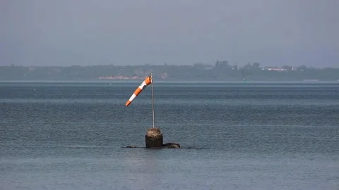 A windsock or wind cone pointing the direction of the wind in the sea Video stock 249241941