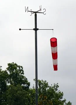 Windsock pointing the wind indicating wind strength and direction. Stock Photos