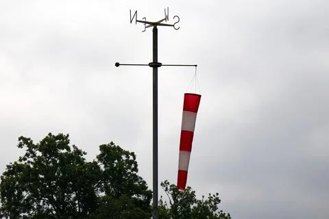Windsock pointing the wind indicating wind strength and direction. Stock Photos