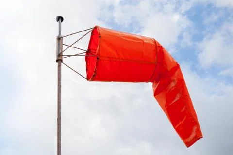 Windsock. Red wind indicator over cloudy sky Stock Photos