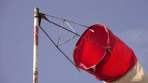 Windsock is rotated in the wind, blue sky background Video stock 158611816