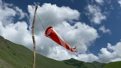 Windsock swaying in the wind at the mountains meadow 스톡 동영상 133894575