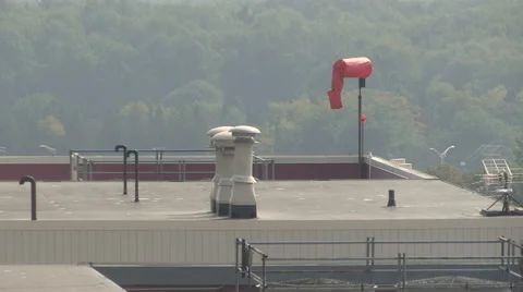 Windsock on top of a commercial building Stock Footage 54162140