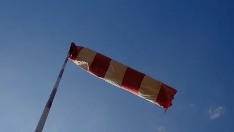 Windsock turning in the wind for a small airstrip Stock Footage 196892963