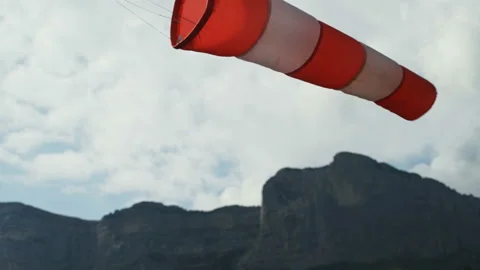 Windsock in the wind. Against background of mountains and sky. Close-up Stock Footage 165366844