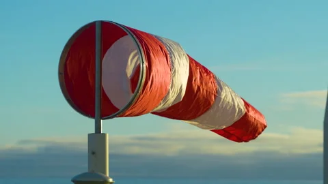 Windsock. Wind blows and stops Close-up. Wind indicator on a metal pole. Blue Stock Footage 228094770