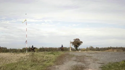 Windsock in wind, meteorology wind sock, two riders on horseback Vidéo 124140413