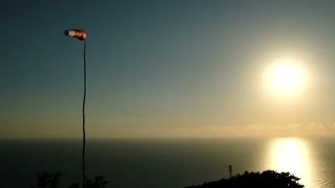 Windsock in the wind on the sunset against sun and the beautiful background of Stock-Footage 200434111