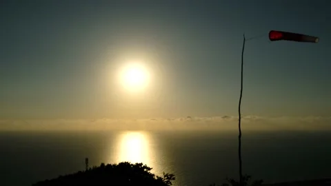 Windsock in the wind on the sunset against sun and the beautiful background of Stock Footage 200434176