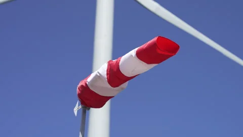 Windsock with a wind wheel in the background. Video stock 325338203