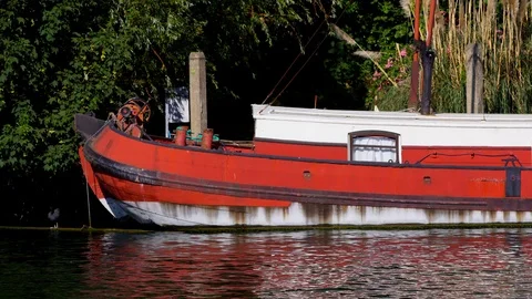 Windsor town 4k on river Thames with red long boat floats by Stock Footage 111336504