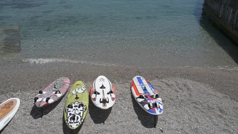 Windsurf boards on the shore, vertical pan Stock Footage 90058569
