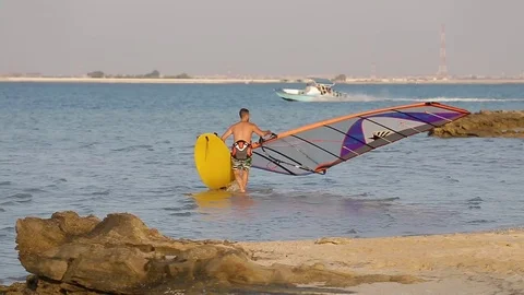 Windsurfer on the beach Stock Footage 71197199