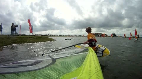 Windsurfer with camera mount in the mast. getting on his surfboard Stock Footage 11542344
